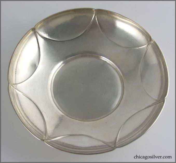 Kalo bowl, on low self foot, with seven semi-circular lobes forming a star pattern when viewed from above
