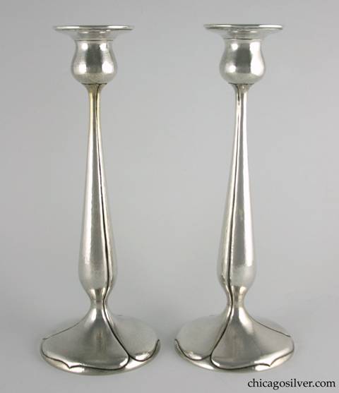 Kalo candlesticks, tall, pair (2), hammered surfaces with pedestal base and tulip form with fluted sides and spade shaped designs on base.  11-15/16" H and 4-5/8" W across base and 2-3/4" W across top.  Marked:  STERLING / HAND WROUGHT / AT / THE KALO SHOP / S402 