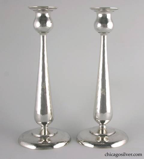 Kalo candlesticks, pair, in tall tulip form with broad round base and tapered, shaped stem with flaring bulb shaped cup.  Hammered all over.  Engraved on the underside "Christmas 1923".  10-3/8" H and 4-5/8" W at base.  Marked:  STERLING / HAND WROUGHT / AT / THE KALO SHOP / G152L