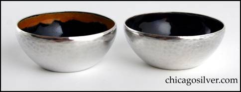 Rebecca Cauman salts, pair (2), enameled, with flat bottom and flaring sides that taper in slightly at the top, and nice hammering.  Interiors have dark rich blue enamel covering most of the surface, with a different color around the top inside edge (one is purple, the other yellow).  Heavy.   