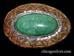 Forest Craft Guild brooch, copper, oval, with acid-etched geometric design around the frame centering a bezel-set oval green replaced stone.  