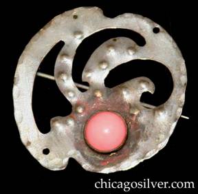 Forest Craft Guild brooch, silvered brass, with notches top and bottom, two curving cutouts at center, three pierced holes around edge, numerous small repousse round domes, and round pink bezel-set cabochon stone at bottom.  
