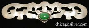 Forest Craft Guild brooch, German silver, rectangular, with rounded ends and extensive cutouts inside and along the outside of the frame.  In the center at the bottom is an oval bezel-set green cabochon stone.