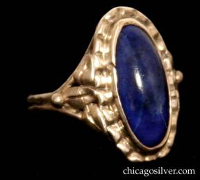 Forest Craft Guild ring, with grooved and worked oval silver frame centering an oval bezel-set deep blue lapis stone.  Three applied stylized leaves and bead ornament on both sides.