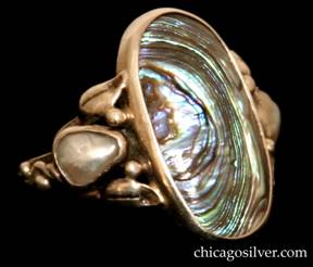 Forest Craft Guild ring, silver, with large oval frame containing an oval bezel-set swirling iridescent blue and silver abalone stone, with smaller bezel-set freeform pearls and applied beads, leaves, and vines on either side.