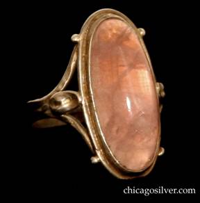 Forest Craft Guild ring, with large oval silver frame centering a large oval translucent cabochon rose quartz stone, with applied leaves on each side and small beaded ornament on the sides top and bottom.