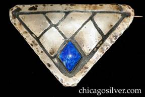 Forest Craft Guild brooch, triangular, large, German silver, with acid-etched border and angled geometric design forming several diamonds and triangles, and a diamond-shaped blue bezel-set stone centered at the bottom.  Hammered edge.