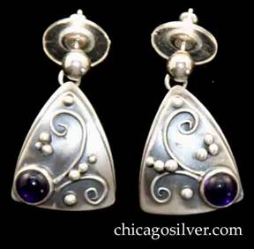 Laurence Foss earrings, pair (2), for pierced ears, rounded triangular slightly convex bodies with smaller triangle applied over slightly larger one.  Silver bead and curving wirework ornament on oxidized background with a purple cabochon bezel-set amethyst stone at one corner.