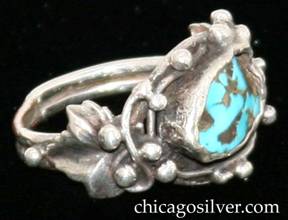 Ring, with freeform bezel-set turquoise stone surrounded by silver beads and curving wires.  On each side is an applied leaf with silver beads.