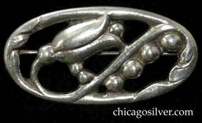 Randahl brooch, oval, with chased and cutout design of a diagonal flower blossom with stem snaking around in an S-shape surrounded by silver beads, and stylized floral elements at either end.  Heavy.
