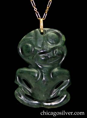 Kalo pendant, jade, with gold loop bale, on conforming gold paperclip chain.  Carved dark green figure in the form of a small primitive seated frog (or man), with a gold loop-shaped bale through a hole at the top of the head with the KALO mark.  