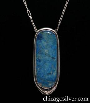 Kalo necklace / pendant, on paperclip chain, with large blue stone.  Long narrow oval frame with small recessed area between frame and bezel.  Bottom is slightly pointed and has three small cutouts following the curve of the stone, centering a very large mottled blue bezel-set stone.  Frame is open on the back.  Chain is connected to two small protruding loops at the upper left and right sides.