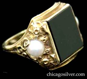 Ring, by Edward Oakes, handwrought in 14K green gold with central black onyx plaque, flanked by bezel-set pearls with fine, highly detailed gold work depicting flowers, scrolls and small beads.  Beautifully crafted, very delicate.