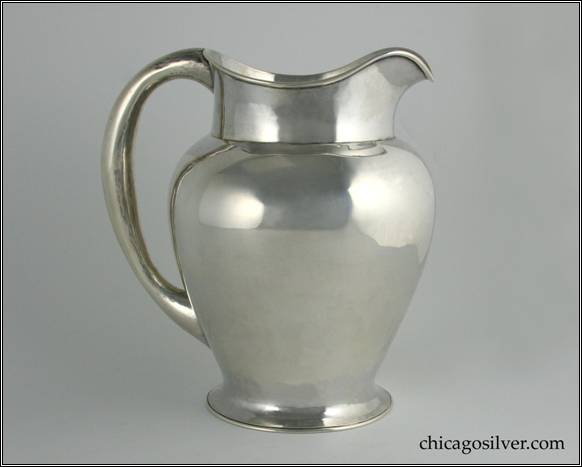 Kalo pitcher, water, on flared round foot with vase-shaped body.  Necked in top with gently curving spout and looping hollow handle.  7-3/4" W and 8-1/2" H.  STERLING / HAND WROUGHT / AT / THE KALO SHOPS / CHICAGO / AND / NEW YORK / 651 / E