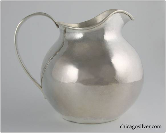 Kalo pitcher, small, squat rounded form on flat bottom with low spout and looping strap handle.  Engraved "1892 June 1 = 1917" on side above base.  Technically the mark is post-1917 (since it lacks the " CHICAGO / AND / NEW YORK" designation), but it is dated 1917.  We've seen several Kalo items with the Chicago/New York mark dated 1918.  It is entirely possible that these items were made earlier and either sold later out of inventory or sold earlier but engraved later.  In any event the mark and engraving on this pitcher suggest that 1917 was a transitional year for the Shop.