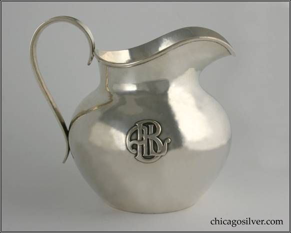 Kalo pitcher, small milk, low squat form with raised spout and applied wire rim, high looping concave strap handle, with applied ALB monogram, hammered surface.  6-1/8" H and 7-3/8" W.  STERLING / HAND WROUGHT / AT / THE KALO SHOP / 9309 / 3  PINTS