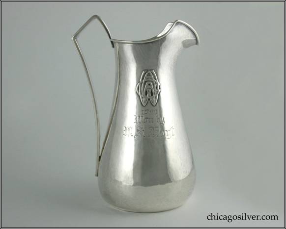 Kalo pitcher, tall and slender, with bulbous bottom, angular strap handle, applied wire to rim, high arching angular spout, applied WGAA mono and engraved "1920 /  Won by / W. S. Hoyt" on side.  Nice condition, beautiful hammering.  8-3/4" H and 5-3/4" W.  STERLING / HAND WROUGHT / AT / THE KALO SHOP / U10L