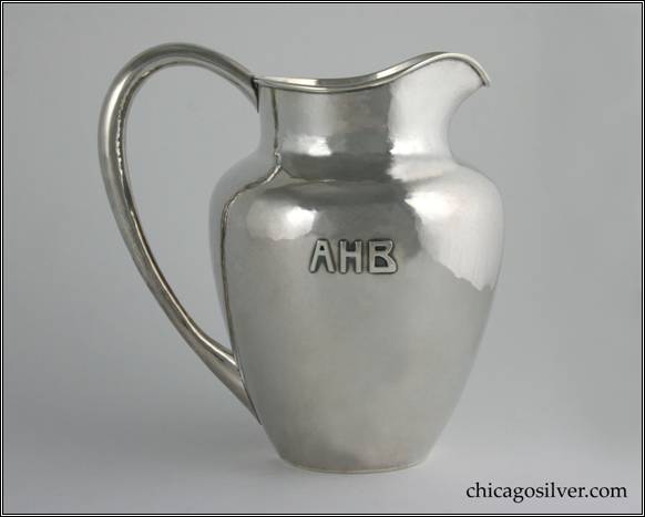 Kalo pitcher, milk jug, small, with looping hollow handle and applied AHB mono on side.  Flat bottom.  Nicely hammered.  6-1/2" W across handle and 6-1/2" H.  STERLING / HAND BEATEN / AT / KALO SHOPS / PARK RIDGE / ILLS.