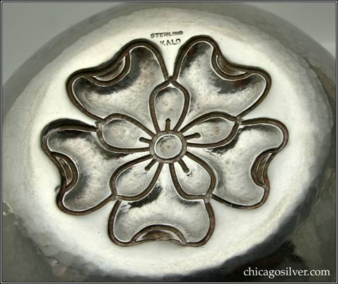 Kalo bowl, early, round, with chased and repouss figure of overlapping blossoms in flat, slightly domed bottom -- bottom view