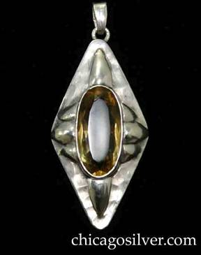 Art Metal Studios pendant, diamond-shaped, centering large bezel-set oval faceted citrine, with single applied silver lobe top and bottom and three lobes on each side.  Bale on loop at top for chain.  Hammered surface.