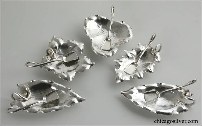 Individual leaf-form footed salts and shovel-form salt spoons by Peer Smed