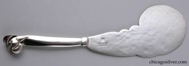 Knife, with heavy solid handle and wide hammered curving blade with freeform scalloped edges.  Fine applied blossom and curving leaves at end of handle.  Heavy.  Made by Peer Smed's daughter Lona P. Schaeffer.