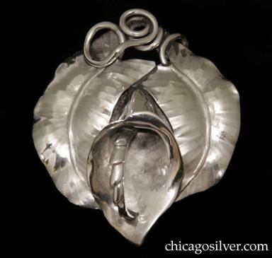 Pin in the form of a jack-in-the-pulpit blossom with a curving chased leaf on each side and thick curving wirework stems at the top.  Large heart-shaped silver disk at back to support pin.  Massive and heavy. Made by Peer Smed's daughter Lona P. Schaeffer.