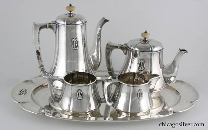 Kalo coffee / tea set with matching tray [and pitcher], six pieces (6) including tray, composed of tea pot, coffee pot, creamer, open sugar, tray, and pitcher, all with applied ML mono.  