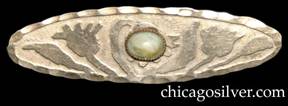 Pin, silver-colored metal, oval, with acid-etched floral pattern centering green and yellow translucent stone