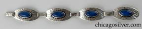Bracelet made of four oval convex links centering bezel-set lapis cabochon stones, with long silver loops connecting them.  Hammered surfaces.  