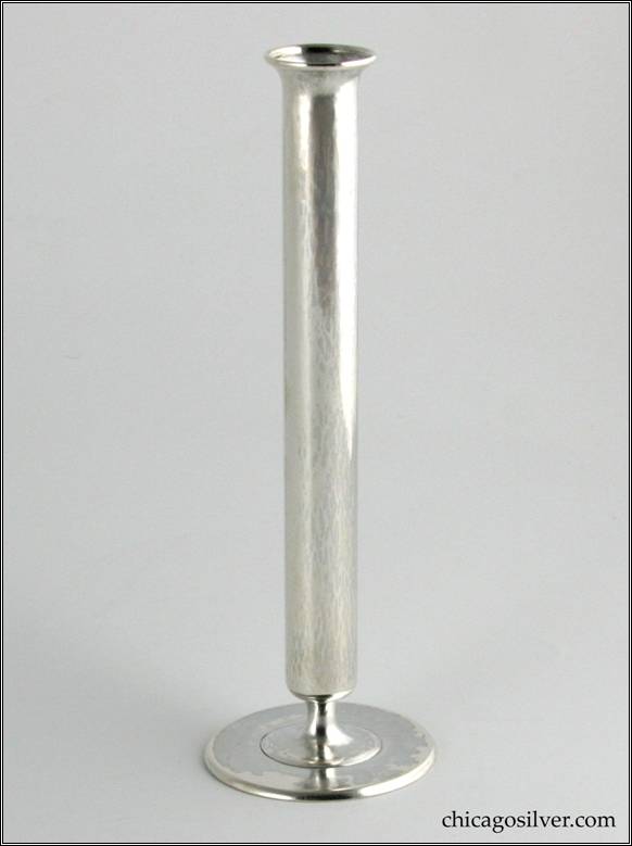 Kalo vase, bud, broad pedestal base with narrow stem supporting a tube-like vessel that flares outward at the top.  Applied wire to rim.  Hammered surface.  7-1/8" H and 2-3/8" W at base.  Marked:  STERLING KALO / 376G